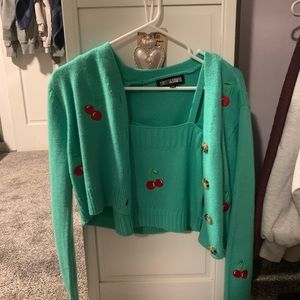 Size medium, the main color is green with red cherrys.
